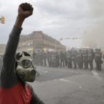 Baltimore protester faces police (photo: Algerina Perna/Baltimore Sun)