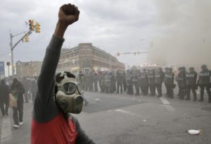 Baltimore protester faces police (photo: Algerina Perna/Baltimore Sun)