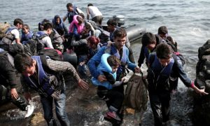 Syrian refugees coming ashore in Greece (photo: Angelos Tzortzinis/Getty)