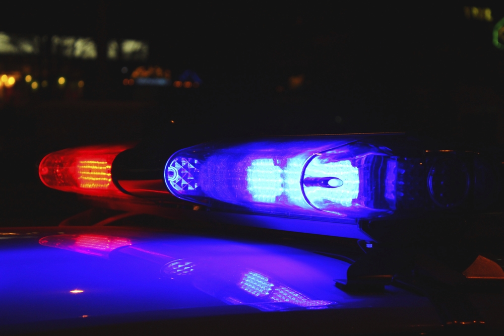 AlterNet used a Shutterstock image of police lights by Alex Schmidt to illustrate its Charlotte coverage.