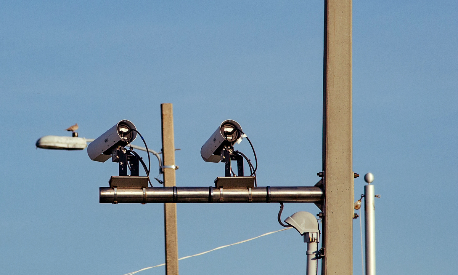 Automated license plate reader (ALPR/LPR) cameras scan license plates of cars crossing into Pensacola Beach, Florida