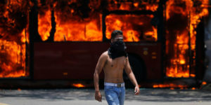 AP Photo of a coup supporter in front of a burning bus(photo: Fernando Llano)
