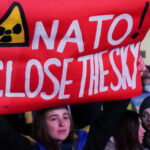 Reuters image of a Ukrainian protest sign saying 'NATO Close the Sky'