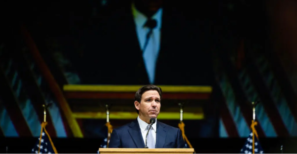 New York Times depiction of Ron DeSantis at a podium.