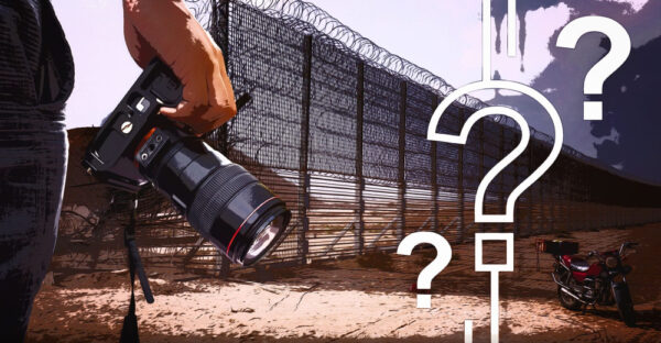 Image from HonestReporting of a camera held by a photographer near a border fence, with superimposed question marks.