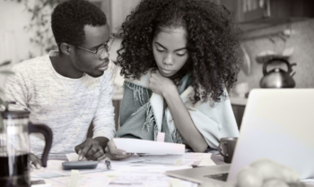 A couple does their taxes, in an image from the report Preying Preparers.