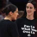 Sports Illustrated depiction of WNBA all-stars Kelsey Plum (left) and Caitlin Clark wearing Pay Us What You Owe Us protest T-shirts