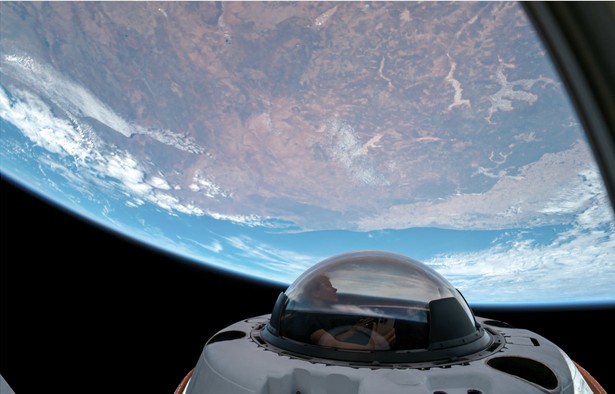 Photo of viewport in space looking down on Earth.