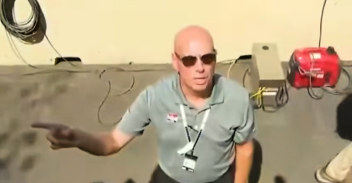 An unidentified IndyCar staffer ordering journalists to stop filming the president.