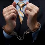 Business executive in handcuffs